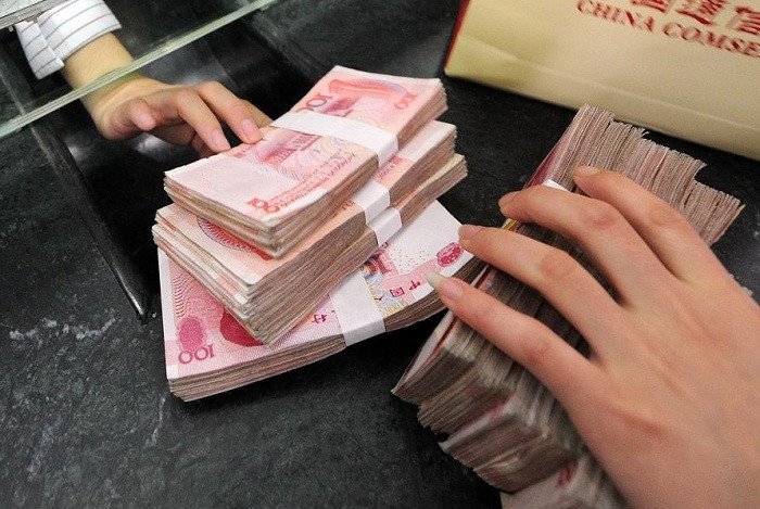 Người đang sử dụng máy tính để thực hiện giao dịch hoặc tìm kiếm thông tin về cách chuyển đổi 1000 tệ sang tiền Việt Nam.
